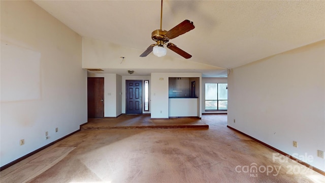 unfurnished living room with carpet floors, high vaulted ceiling, and ceiling fan