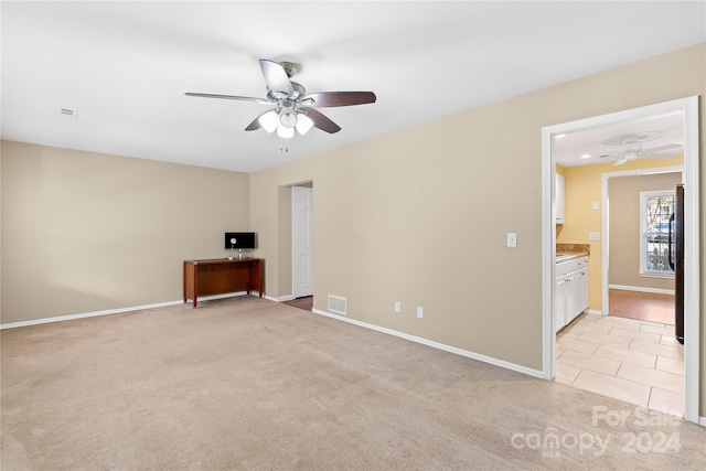 unfurnished room featuring ceiling fan and light colored carpet