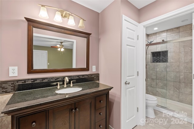 bathroom featuring ceiling fan, tile patterned floors, toilet, vanity, and a shower with shower door