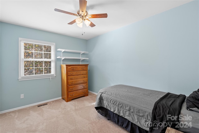 bedroom featuring light colored carpet and ceiling fan