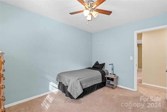 bedroom with ceiling fan and light colored carpet