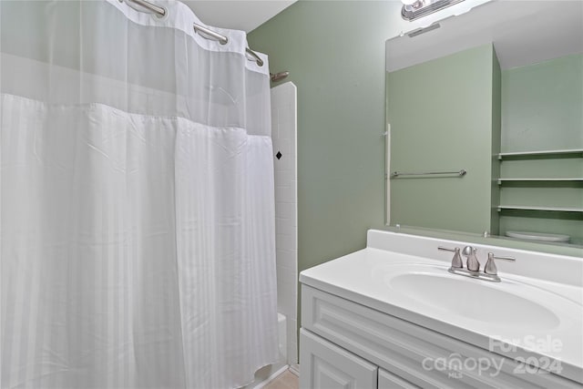 full bathroom featuring shower / bath combination with curtain, toilet, and vanity