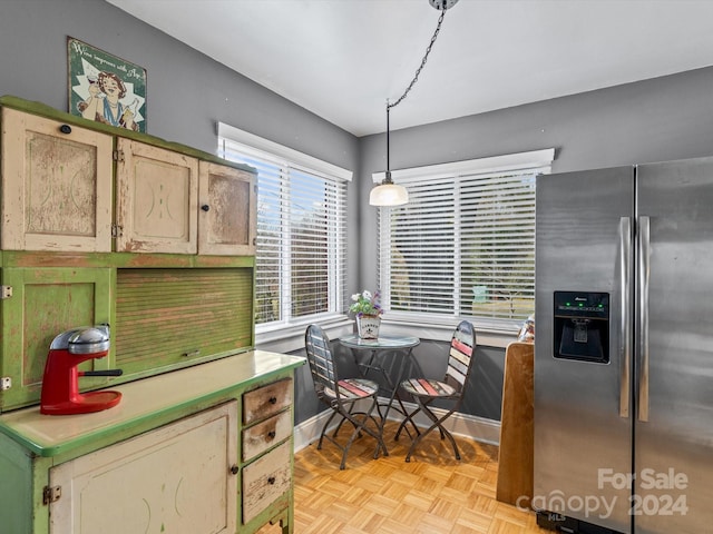 kitchen with stainless steel fridge, light parquet floors, and pendant lighting