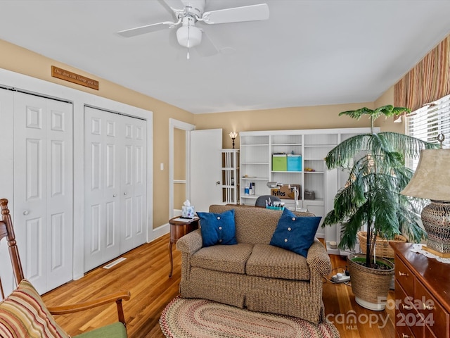 living room featuring ceiling fan and wood-type flooring