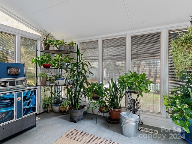 sunroom / solarium featuring vaulted ceiling