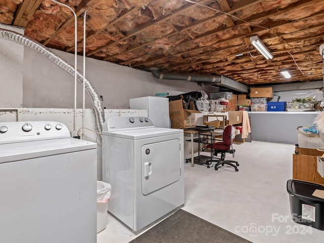 clothes washing area with separate washer and dryer