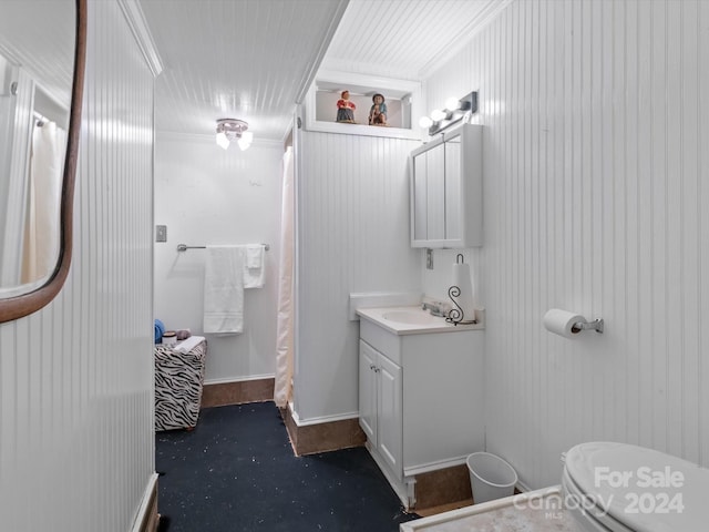 bathroom featuring vanity, ornamental molding, and toilet