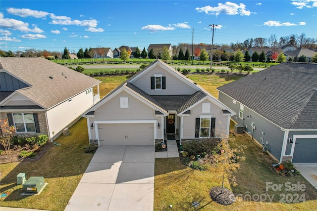 view of front of home with a front lawn and cooling unit