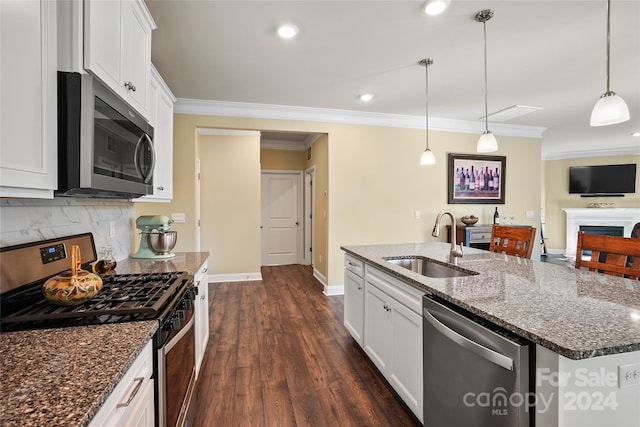 kitchen with appliances with stainless steel finishes, sink, a center island with sink, white cabinets, and dark hardwood / wood-style floors