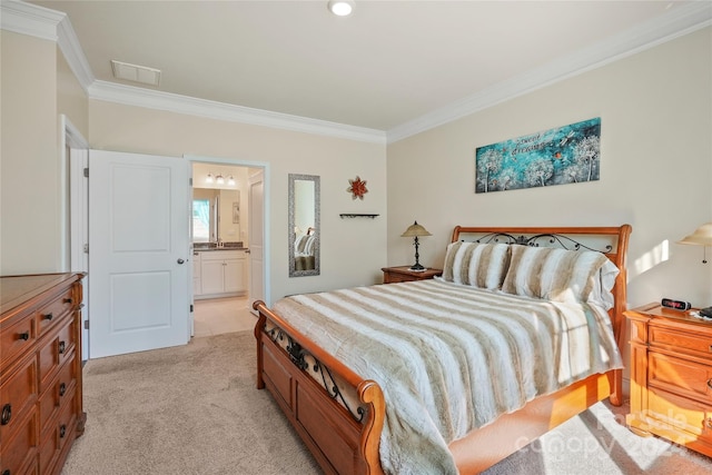 bedroom featuring light colored carpet, ensuite bath, and crown molding