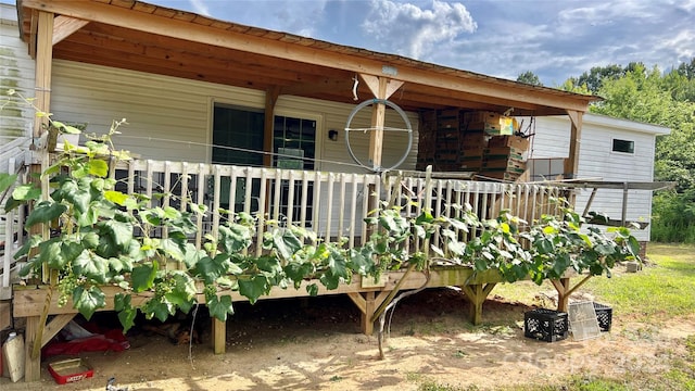 rear view of property featuring a wooden deck