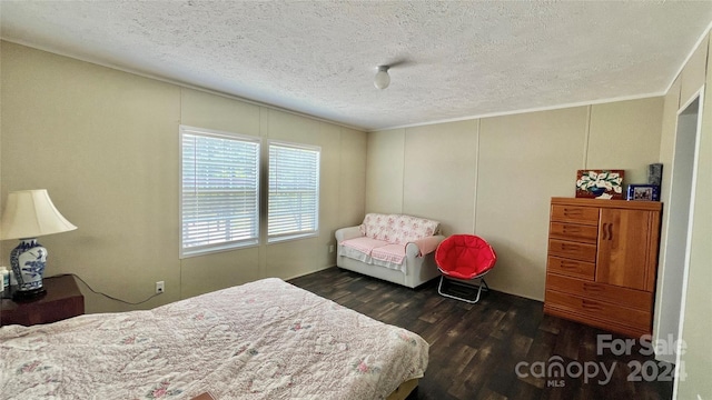 bedroom featuring dark hardwood / wood-style flooring and a textured ceiling