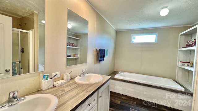 bathroom with vanity, hardwood / wood-style floors, plus walk in shower, and a textured ceiling