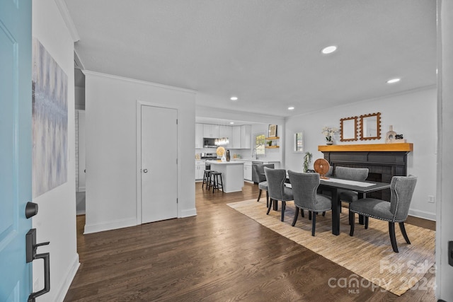 dining area featuring hardwood / wood-style flooring and crown molding