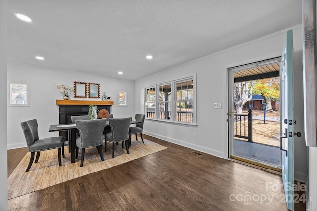 dining area featuring hardwood / wood-style flooring and ornamental molding