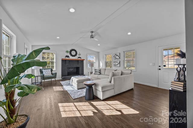 living room featuring a fireplace, dark wood-type flooring, a wealth of natural light, and lofted ceiling