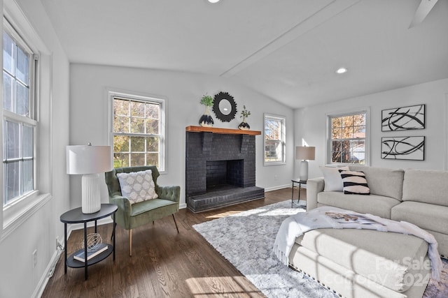 living room with a fireplace, vaulted ceiling with beams, and dark hardwood / wood-style floors