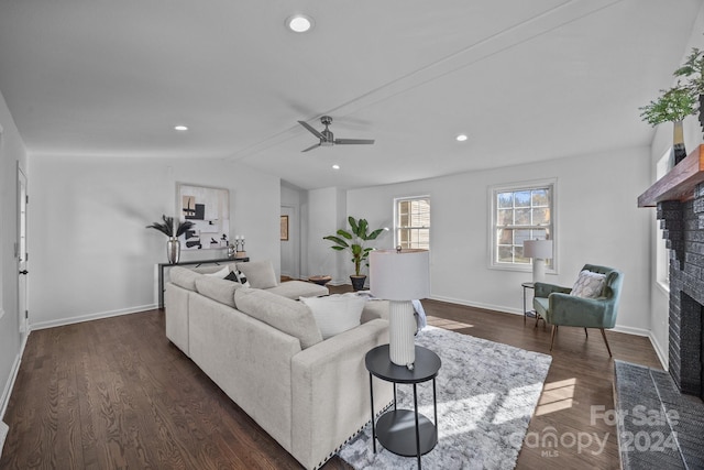 living room with a fireplace, dark hardwood / wood-style flooring, ceiling fan, and lofted ceiling