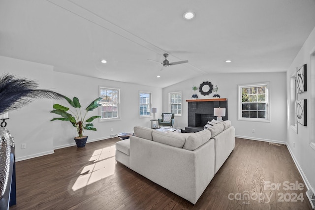 living room with dark hardwood / wood-style floors, a wealth of natural light, and lofted ceiling