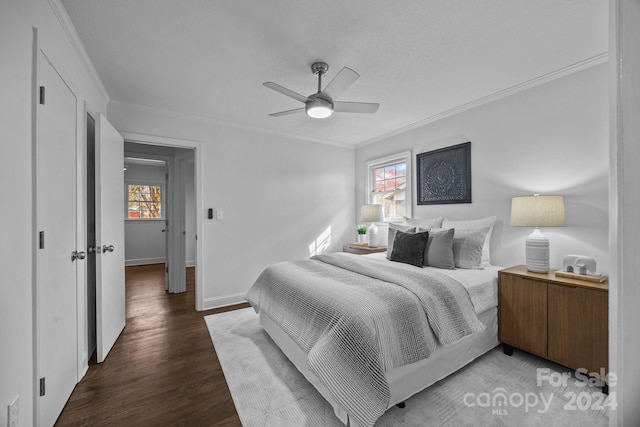 bedroom with multiple windows, ceiling fan, crown molding, and wood-type flooring