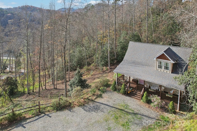 view of property exterior with covered porch and a mountain view