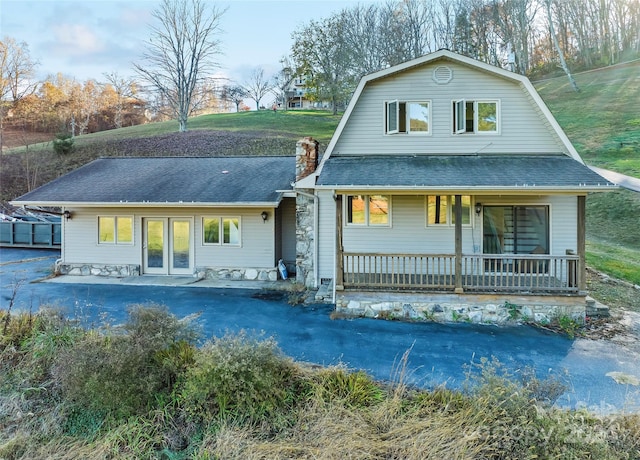 rear view of property with a porch