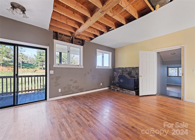 interior space featuring hardwood / wood-style floors, vaulted ceiling with beams, and wood ceiling