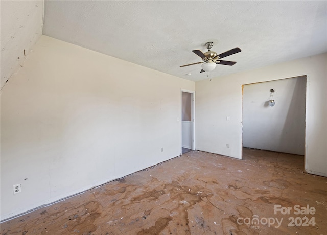 spare room with a textured ceiling and ceiling fan