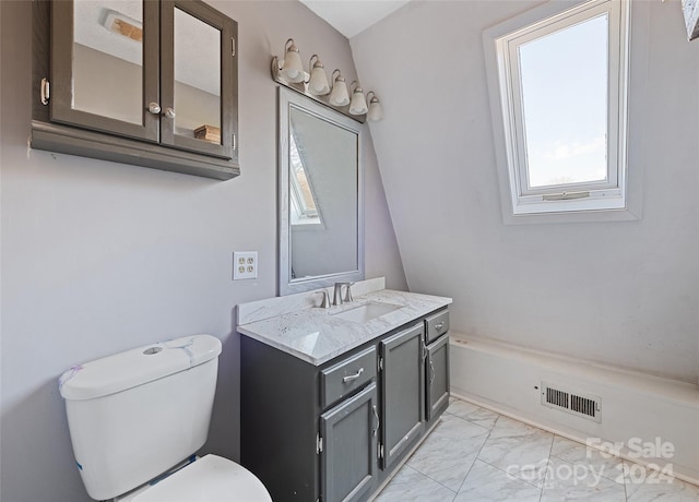 bathroom featuring vanity, a bathtub, and toilet