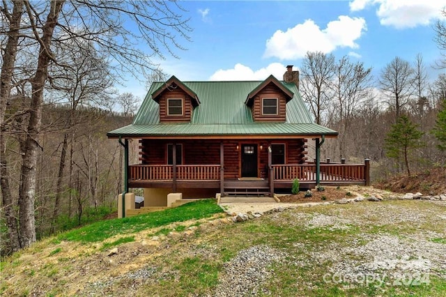 552 Lake Rd, Old Fort, NC 28762 - log home featuring log siding, covered porch, and a chimney