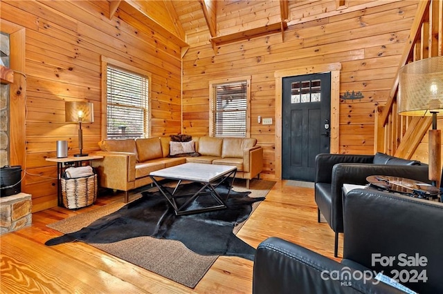 living room with beam ceiling, wooden walls, high vaulted ceiling, and wood-type flooring