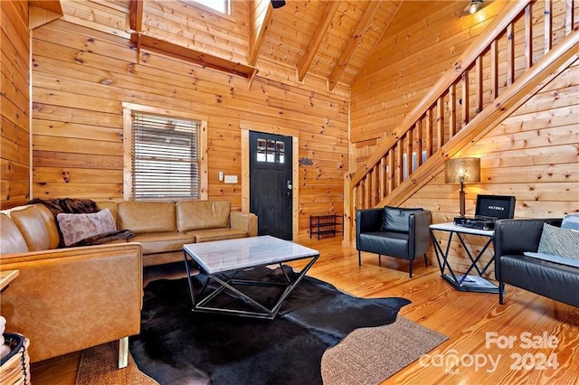 living room with wood walls, high vaulted ceiling, wood-type flooring, and wooden ceiling