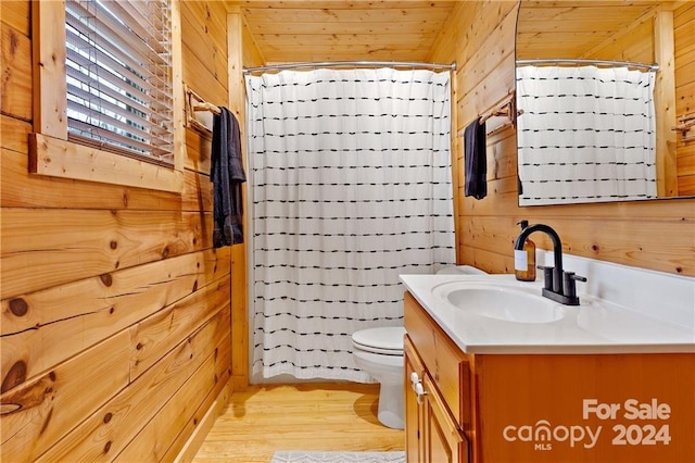 bathroom featuring wooden ceiling, wood walls, wood-type flooring, toilet, and vanity