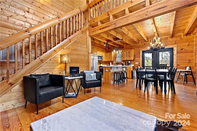 552 Lake Rd, Old Fort, NC 28762 - living area with a chandelier, wooden walls, light wood-style floors, stairway, and french doors