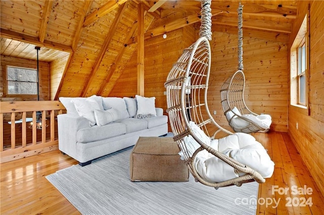 living room featuring hardwood / wood-style floors, vaulted ceiling with beams, wooden ceiling, and wooden walls