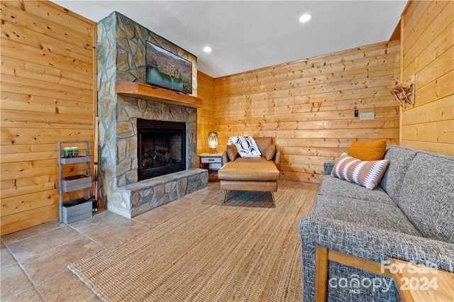 living room featuring wood walls and a fireplace