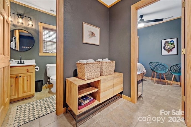 bathroom featuring tile patterned flooring, vanity, toilet, and ceiling fan