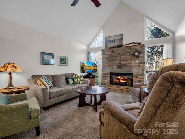 carpeted living room featuring ceiling fan, high vaulted ceiling, and a fireplace