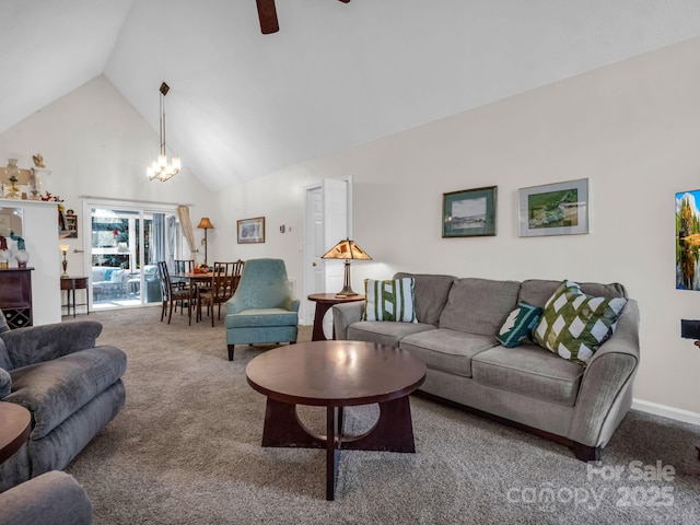 carpeted living room with high vaulted ceiling, baseboards, and ceiling fan with notable chandelier