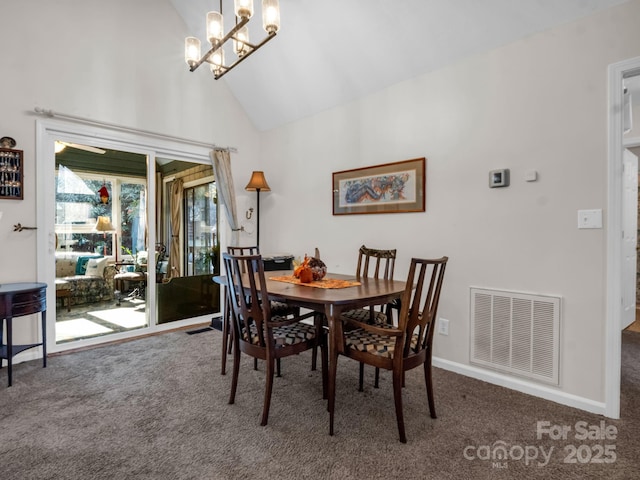 carpeted dining area with high vaulted ceiling, visible vents, baseboards, and an inviting chandelier