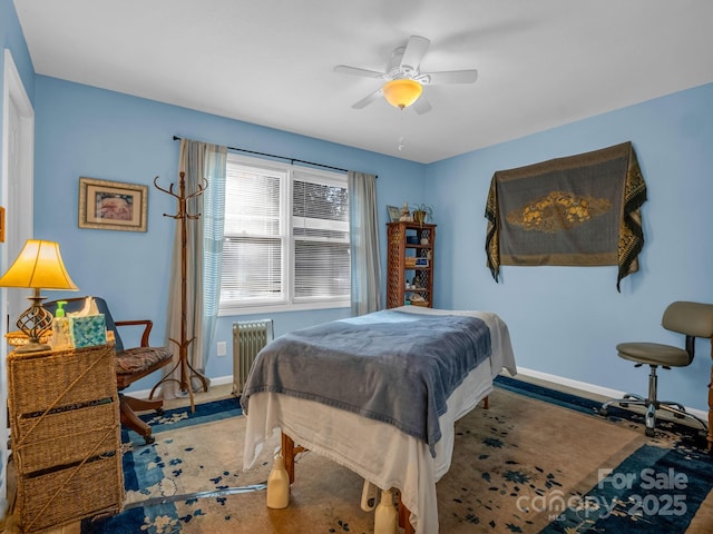 bedroom with baseboards, ceiling fan, and radiator