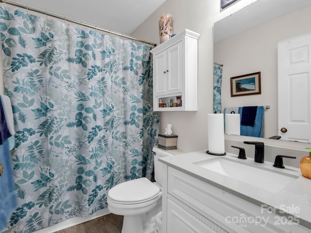 bathroom with a shower with curtain, vanity, toilet, and wood finished floors