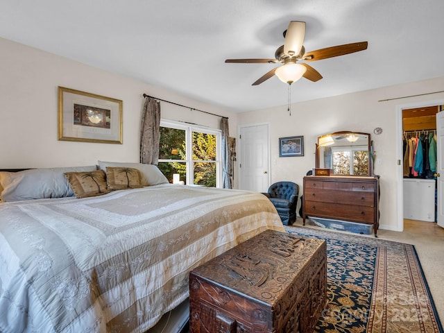 carpeted bedroom featuring ceiling fan, a spacious closet, and a closet