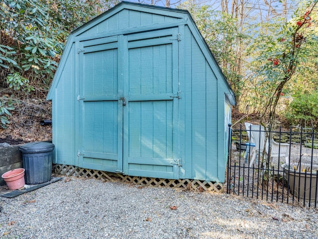 view of shed featuring fence