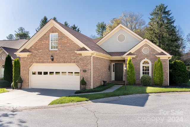 front facade with a front lawn and a garage