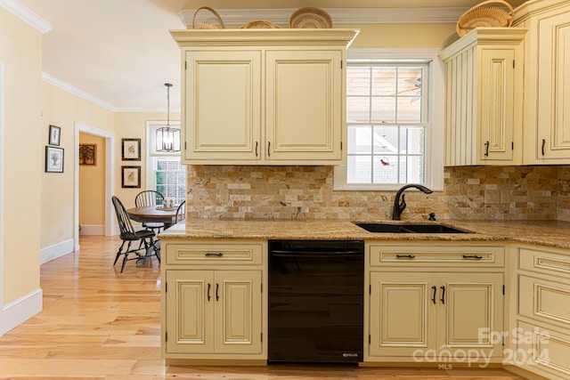 kitchen featuring cream cabinetry, light hardwood / wood-style floors, a healthy amount of sunlight, and sink