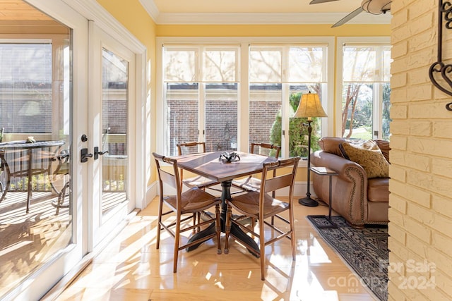 sunroom / solarium featuring ceiling fan