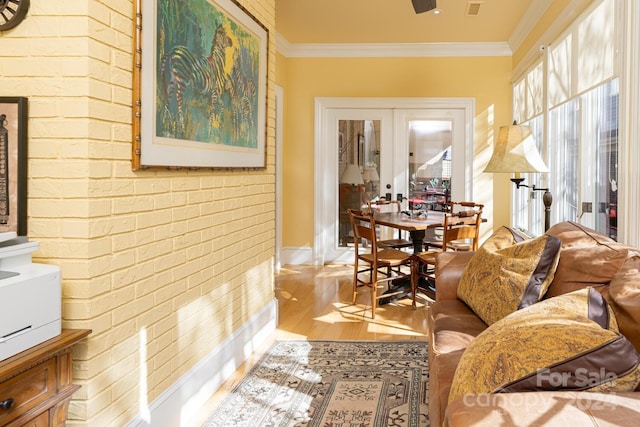 living room featuring hardwood / wood-style floors, french doors, and crown molding