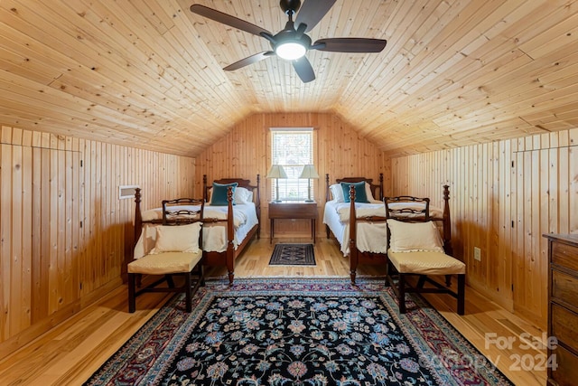 bedroom featuring ceiling fan, wood walls, light hardwood / wood-style floors, lofted ceiling, and wood ceiling