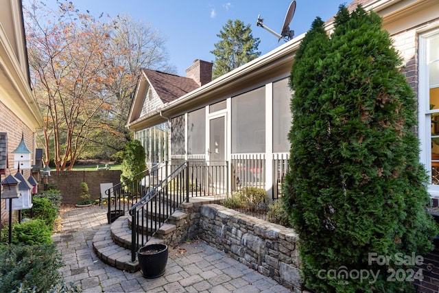 view of patio with a sunroom